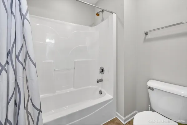 a bathroom with a toilet and a bathtub