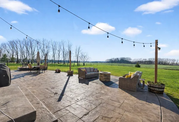 a view of a swimming pool and chairs in the patio