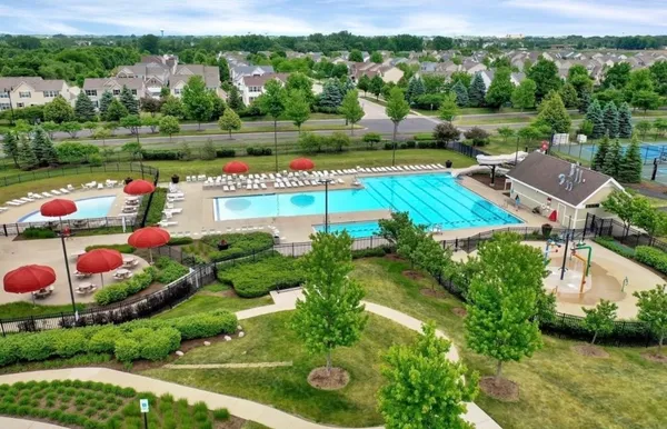 a view of swimming pool with a yard and lake view