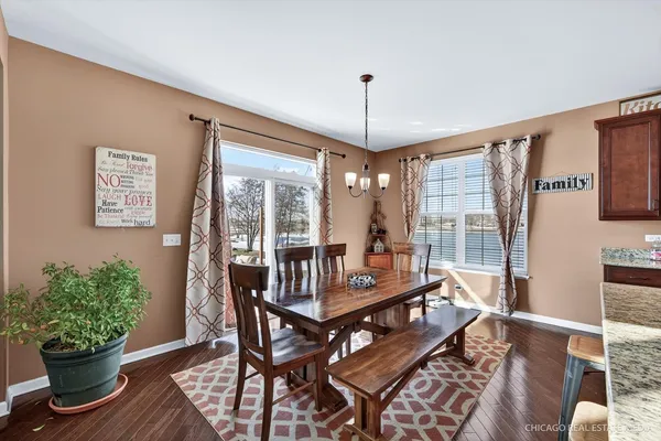 a view of a dining room with furniture window and wooden floor
