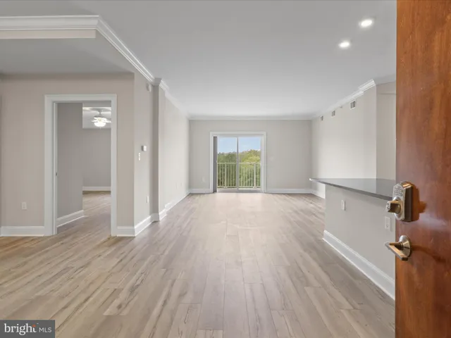 a view of a room with wooden floor and window