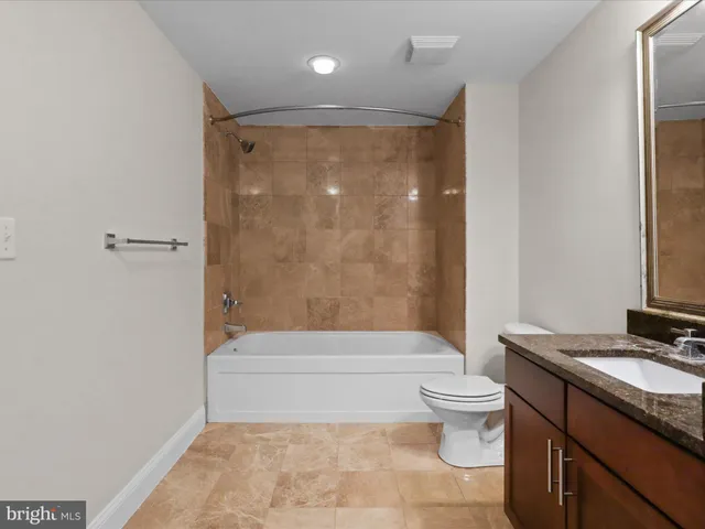 a bathroom with a shower a toilet and sink