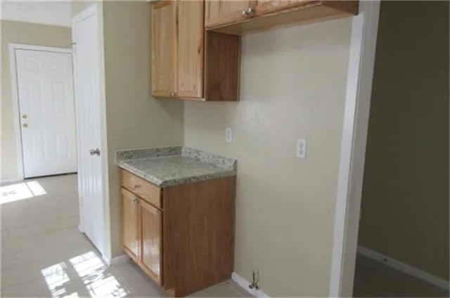a utility room with wooden floor washer and dryer