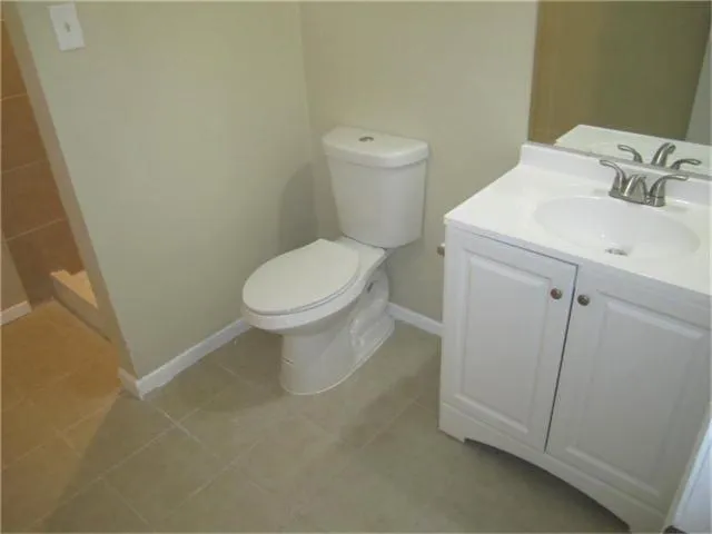 a white toilet sitting next to a bathroom sink