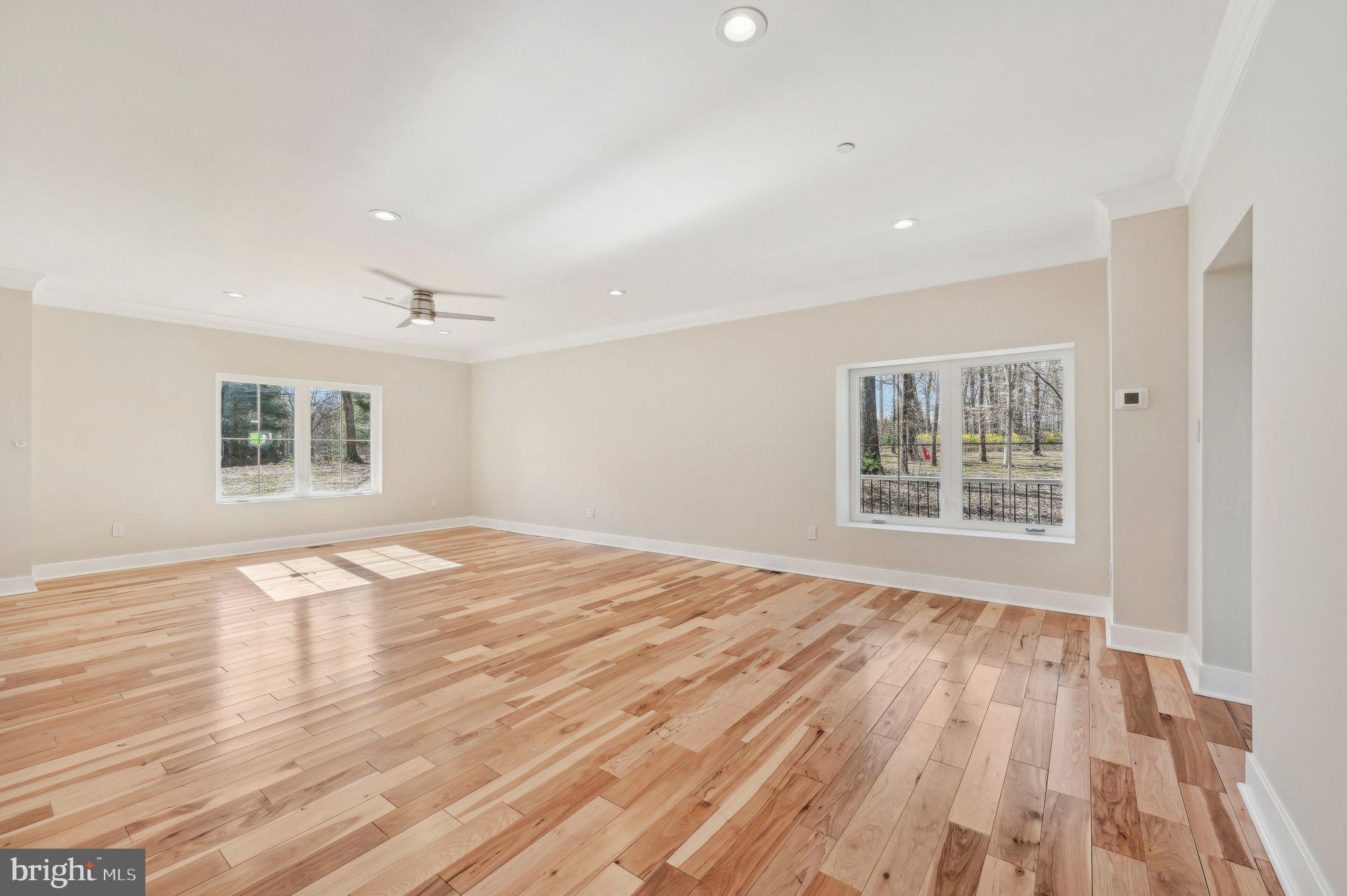11990 Hall Shop Road Clarksville, MD 21029 - Photo 12 of 64 a view of an empty room with wooden floor and a window