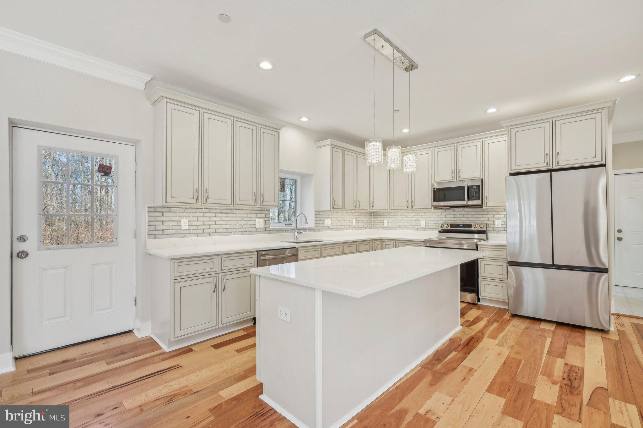 11990 Hall Shop Road Clarksville, MD 21029 - Photo 15 of 64 a kitchen with refrigerator cabinets and a sink