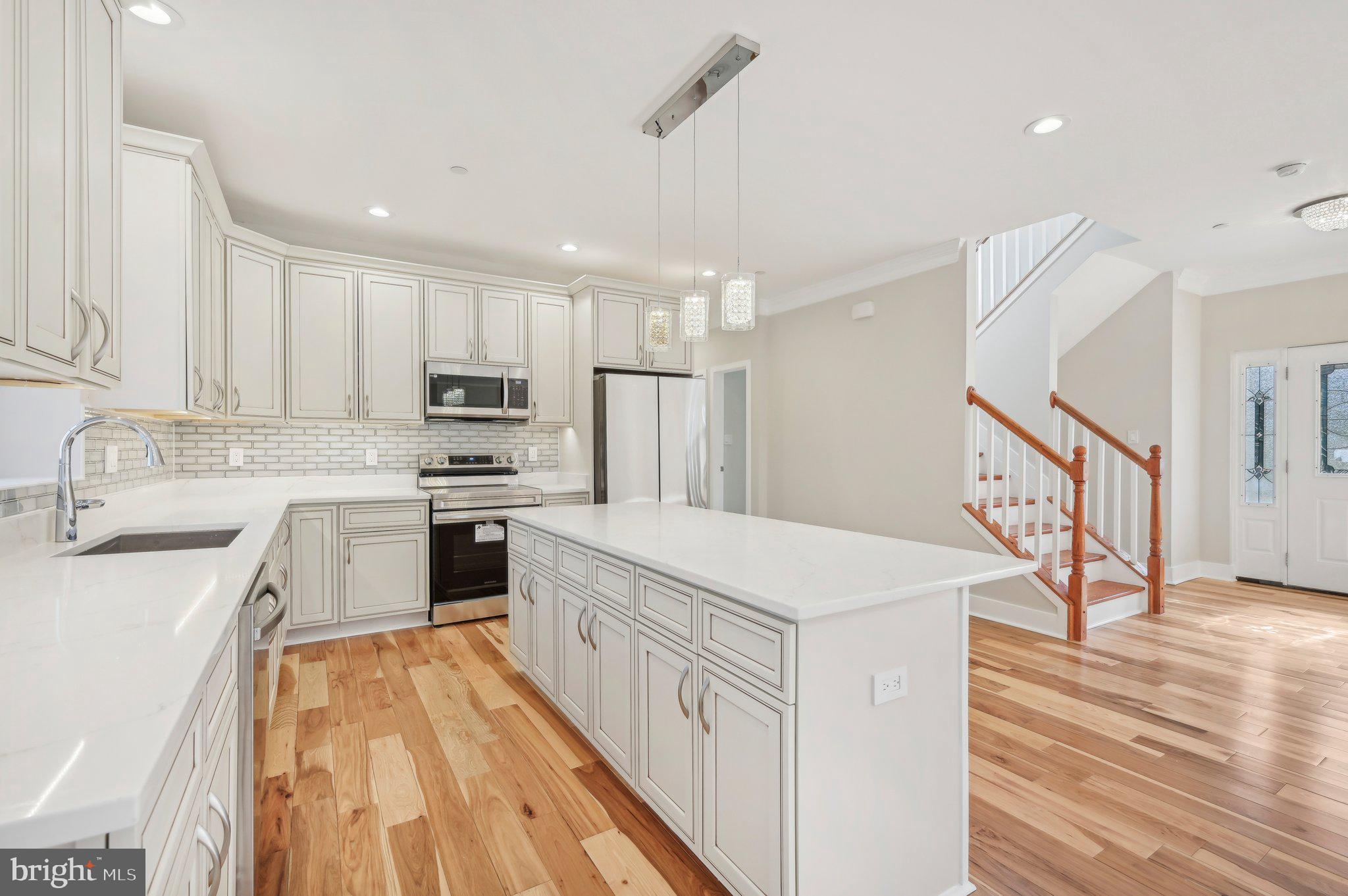 11990 Hall Shop Road Clarksville, MD 21029 - Photo 16 of 64 a kitchen with white cabinets sink and stainless steel appliances
