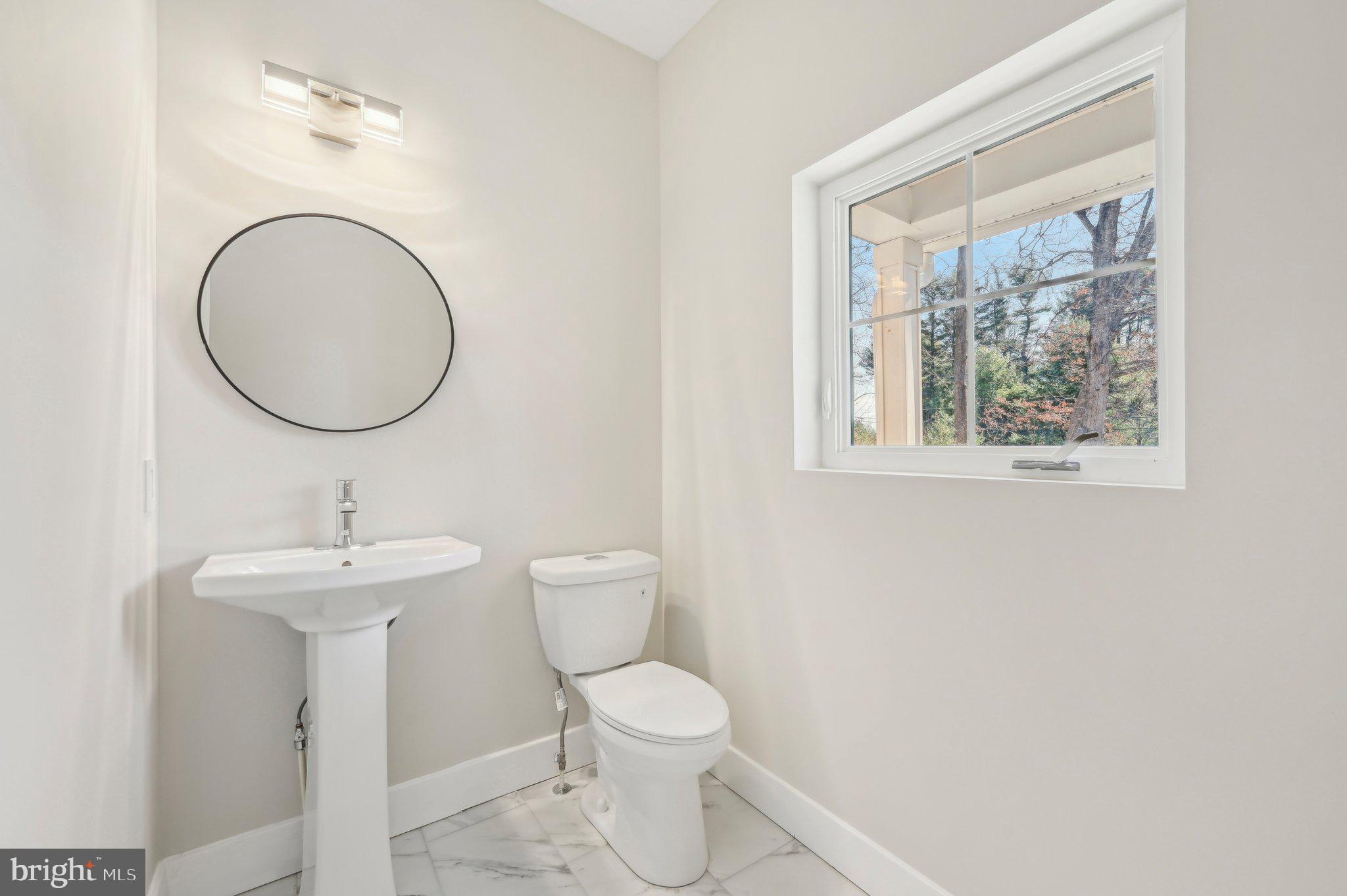 11990 Hall Shop Road Clarksville, MD 21029 - Photo 25 of 64 a bathroom with a toilet a sink and a mirror