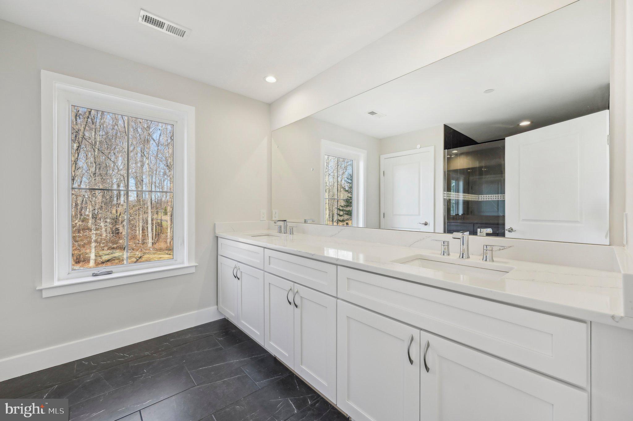 11990 Hall Shop Road Clarksville, MD 21029 - Photo 46 of 64 a bathroom with double sink and a window