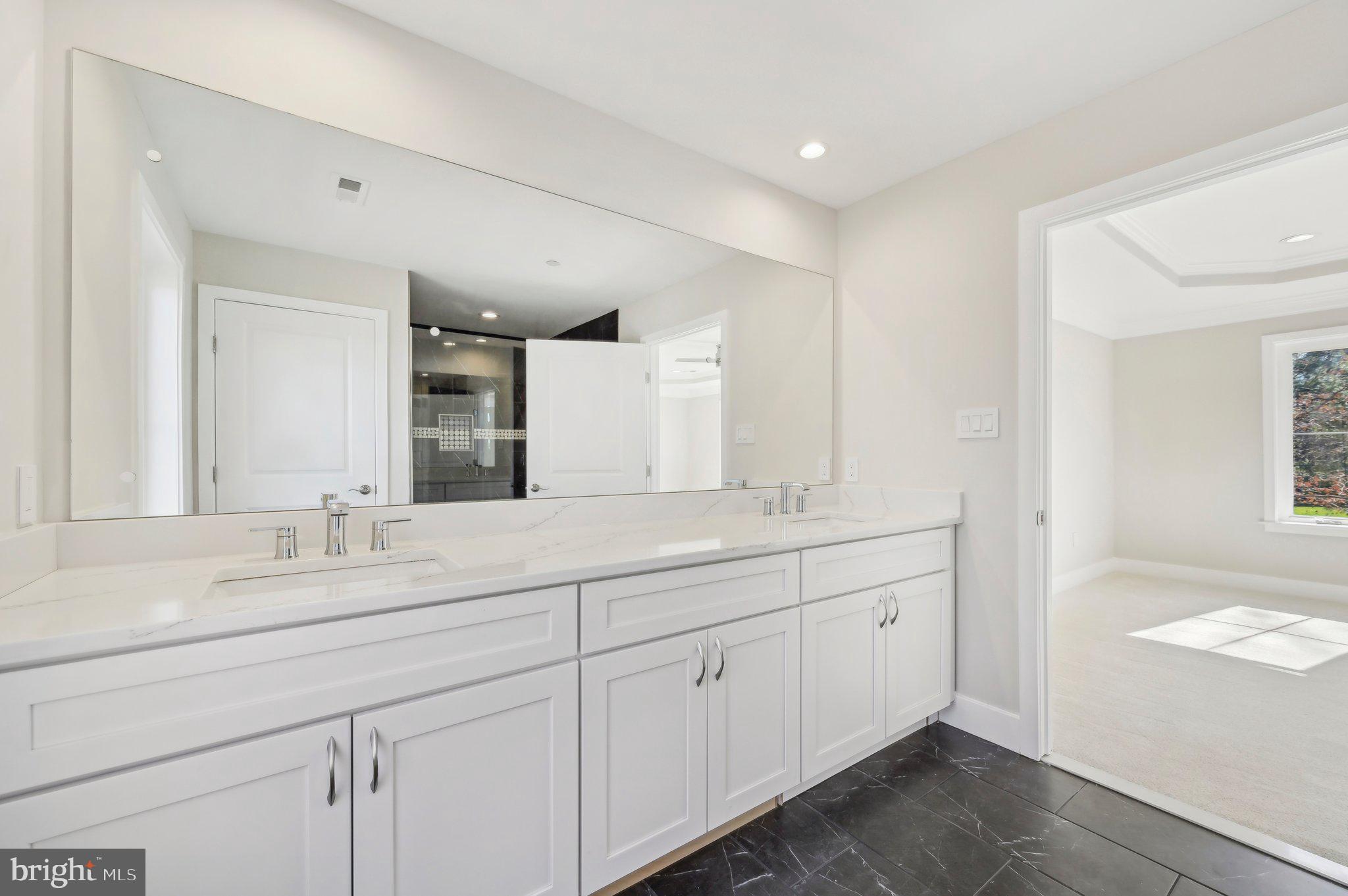 11990 Hall Shop Road Clarksville, MD 21029 - Photo 47 of 64 a bathroom with double sink and a mirror