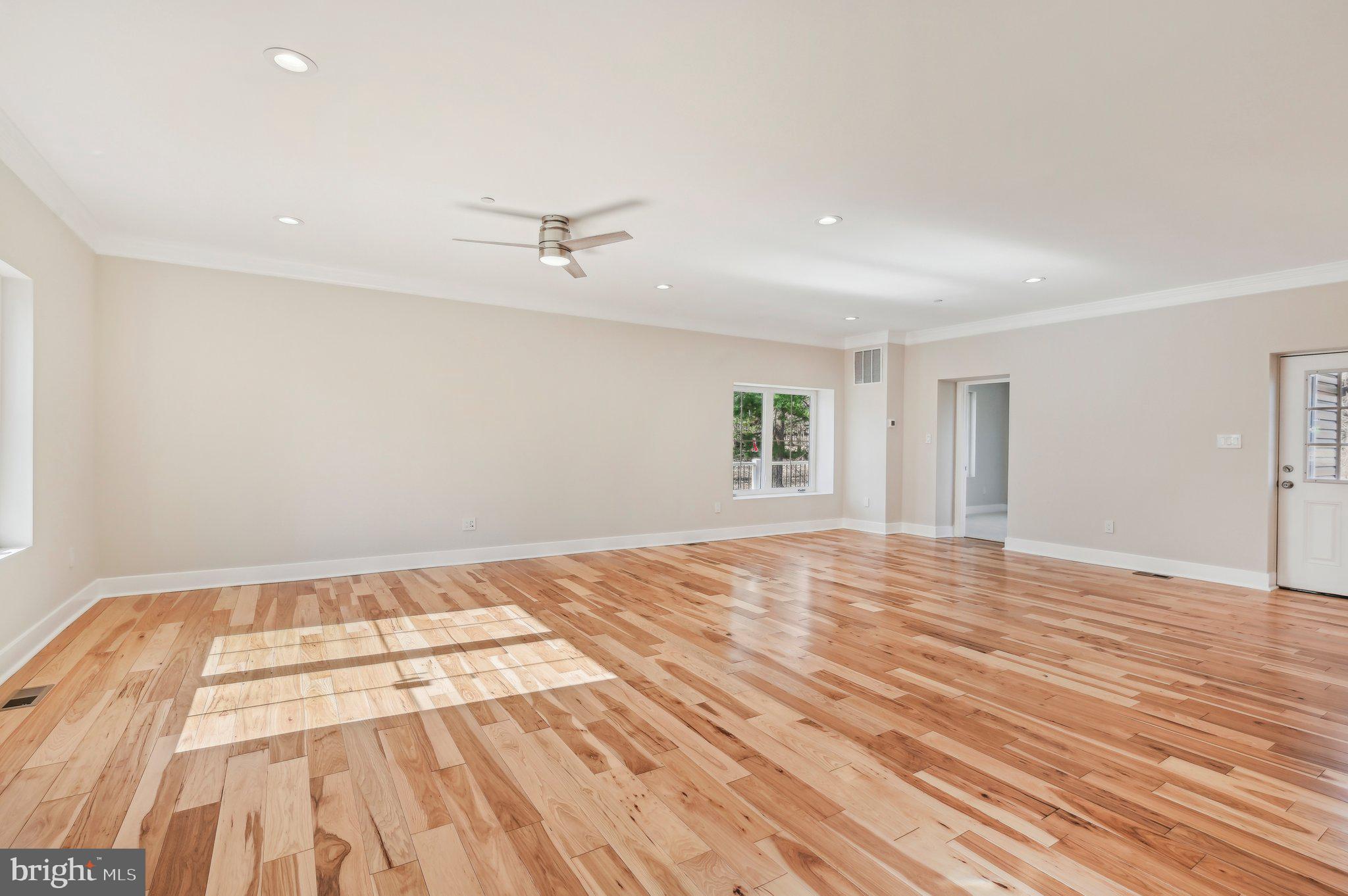 11990 Hall Shop Road Clarksville, MD 21029 - Photo 5 of 64 a view of an empty room with wooden floor and a window