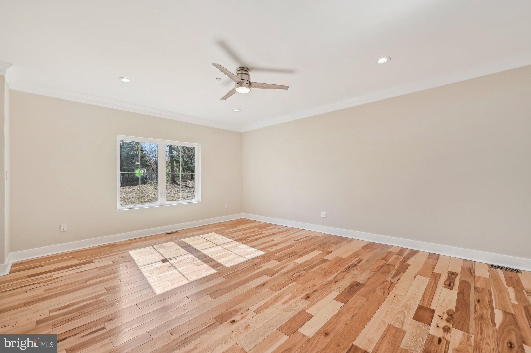 11990 Hall Shop Road Clarksville, MD 21029 - Photo 6 of 64 a view of an empty room with wooden floor and a window