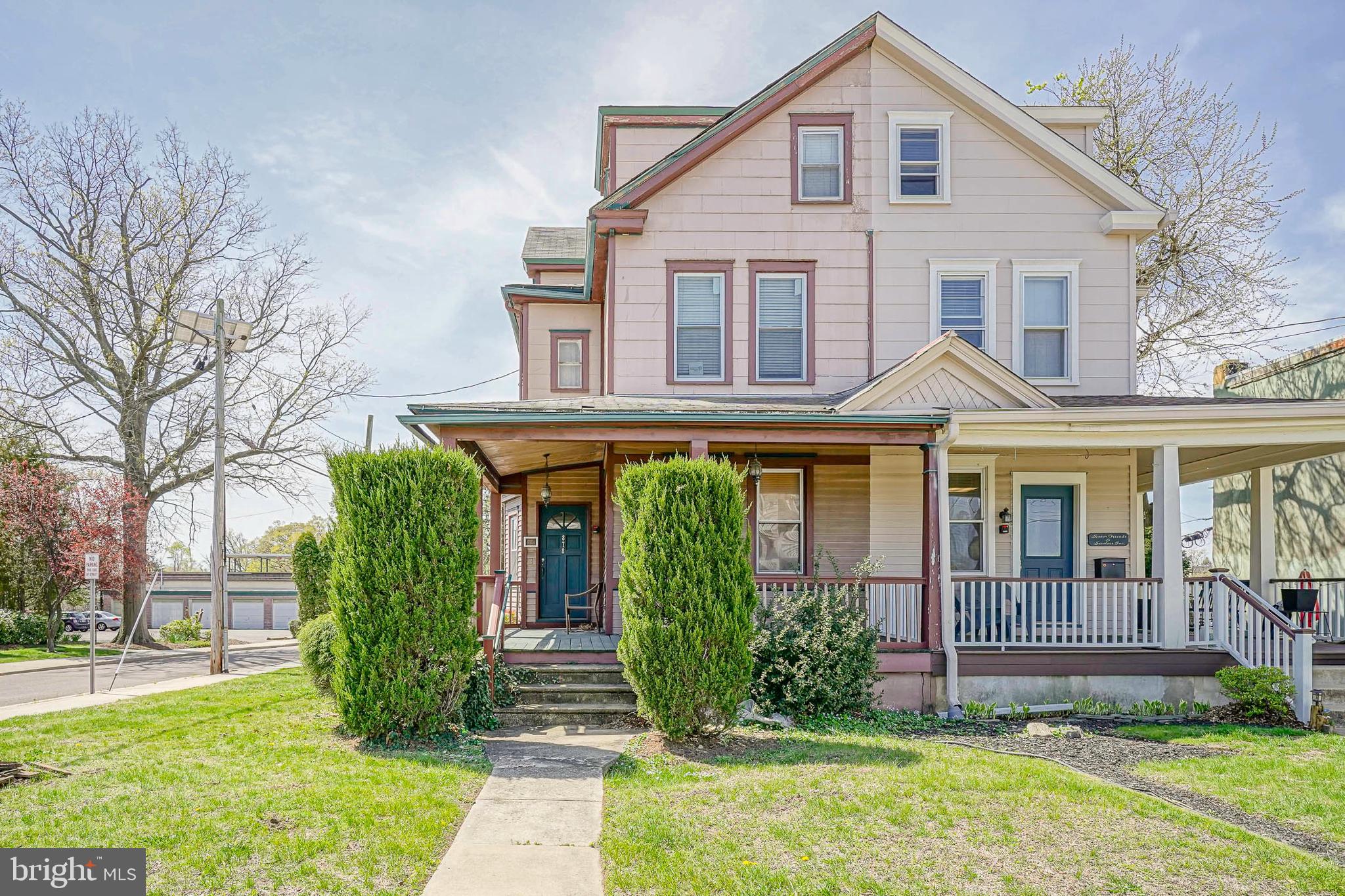 a view of a house with brick walls and a yard with plants