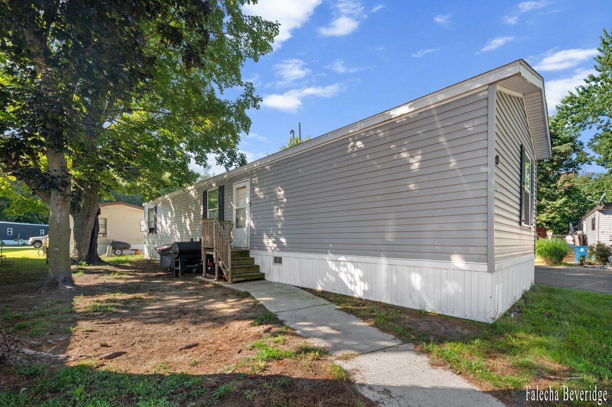 1281 East Pontaluna Road, Unit 101 Spring Lake, MI 49456 - Photo 1 of 18 EXTERIOR