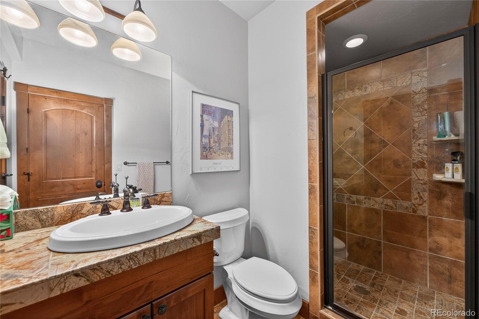 148 County Road Tabernash, CO 80478 - Photo 22 of 45 a bathroom with a granite countertop sink a toilet and a mirror