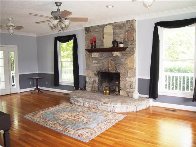 3096 Dodson Gap Road Culleoka, TN 38451 - Photo 4 of 20 Living Room with wood burning rock fireplace and lots of windows for natural light