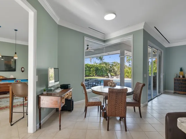 a room with dining table and chairs