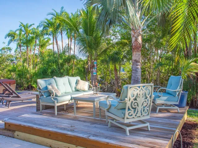 a view of a fountain in a yard with palm trees