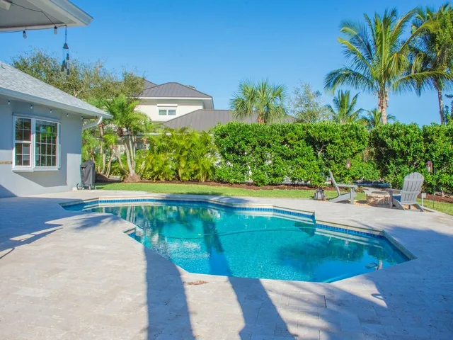 a view of swimming pool with an outdoor space and seating area