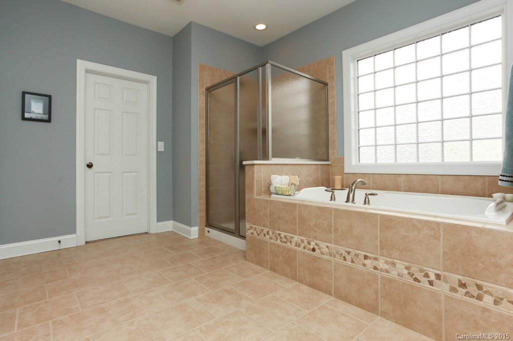 671 Revival Row Fort Mill, SC 29708 - Photo 18 of 24 a bathroom with a bathtub and a shower