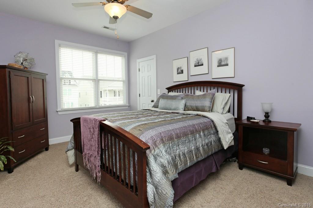671 Revival Row Fort Mill, SC 29708 - Photo 19 of 24 a bedroom with a bed and a chandelier