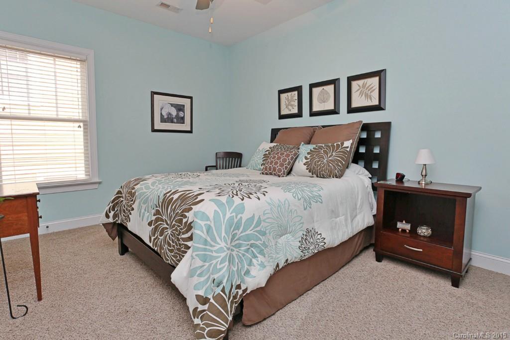 671 Revival Row Fort Mill, SC 29708 - Photo 21 of 24 a bedroom with a bed and a lamp on table