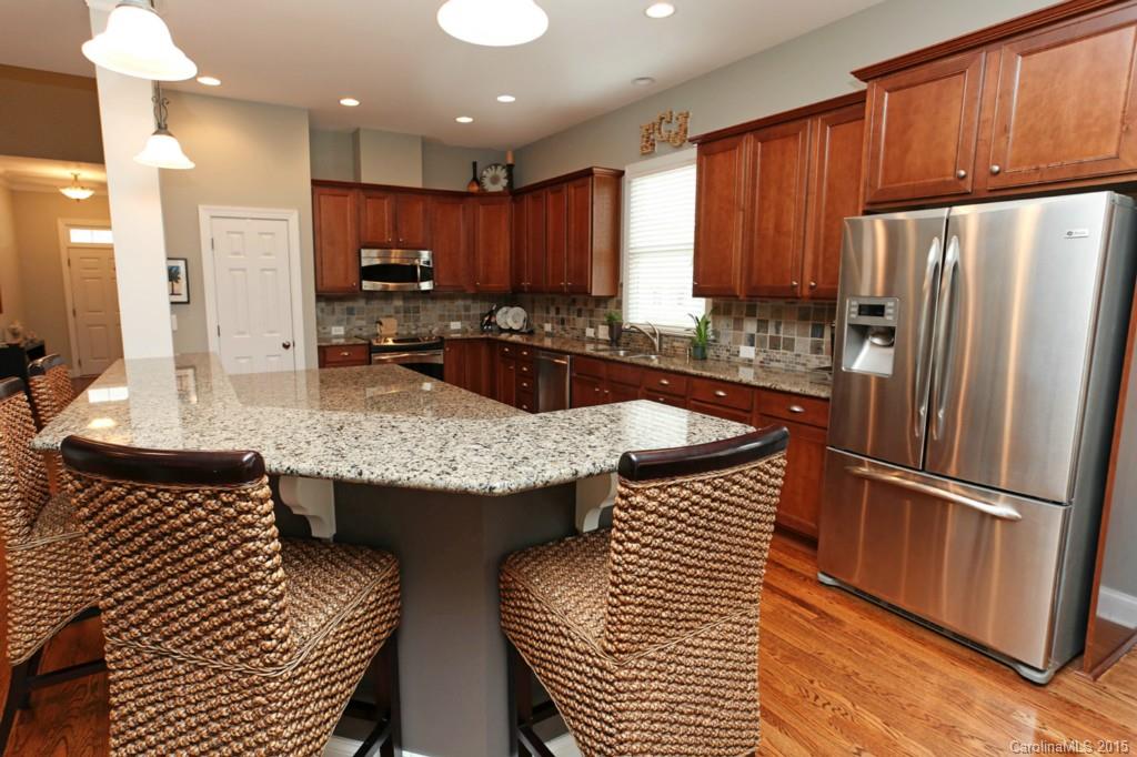 671 Revival Row Fort Mill, SC 29708 - Photo 6 of 24 a kitchen with stainless steel appliances granite countertop a sink refrigerator and cabinets