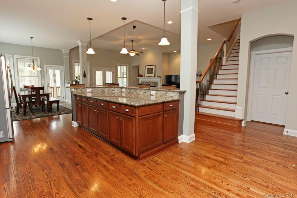 671 Revival Row Fort Mill, SC 29708 - Photo 8 of 24 a kitchen with stainless steel appliances granite countertop wooden floors and granite counter tops