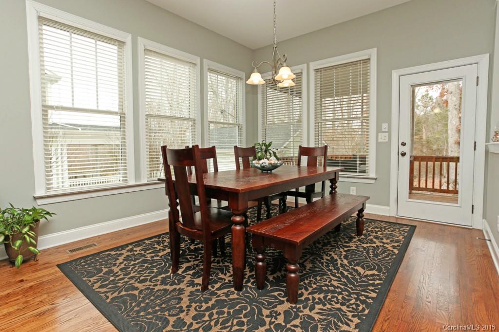 671 Revival Row Fort Mill, SC 29708 - Photo 10 of 24 a dining room with wooden floor a chandelier table and chairs
