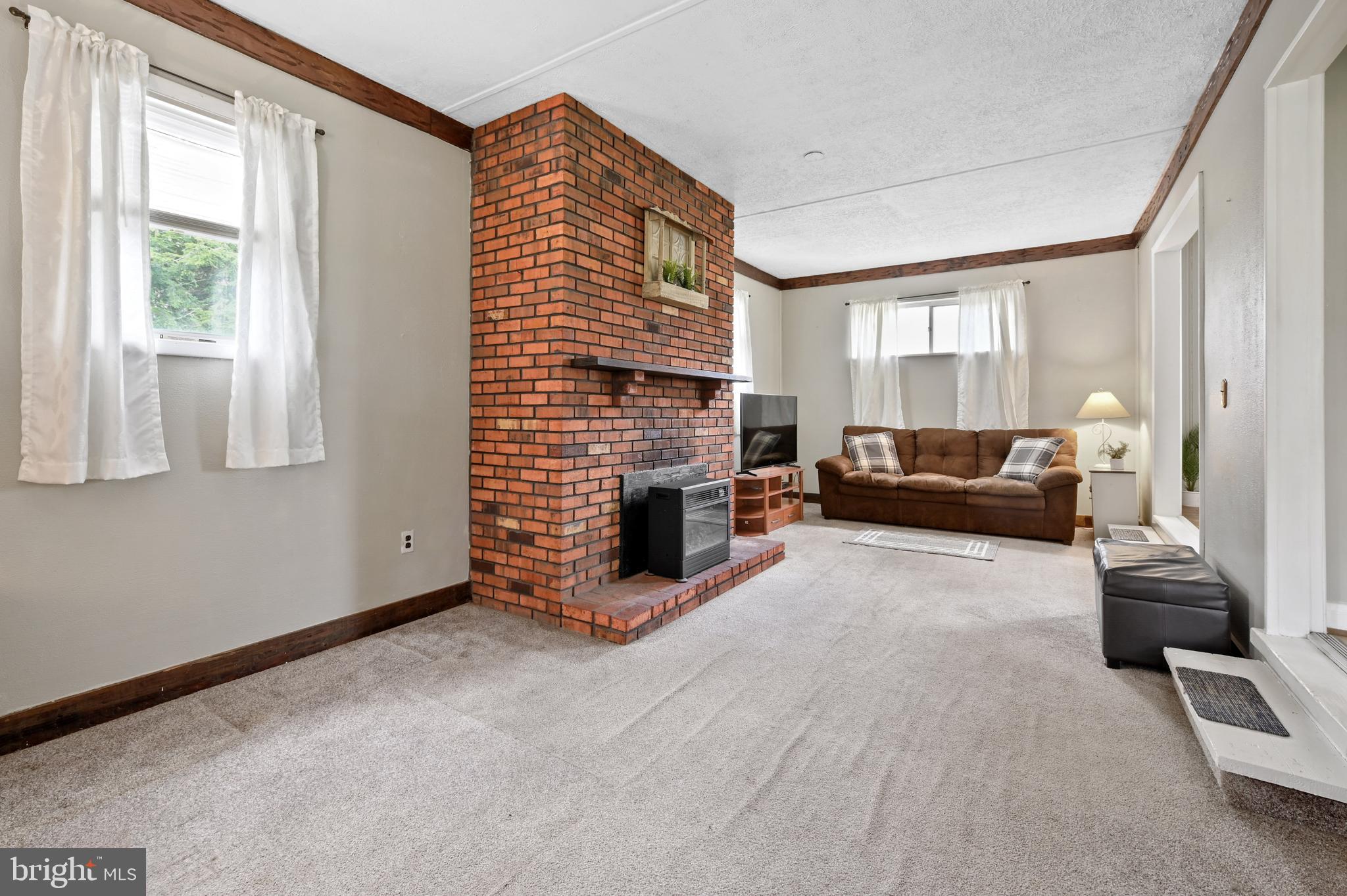 8437 Alvin Road Pasadena, MD 21122 - Photo 14 of 39 Bonus room with electric fireplace.