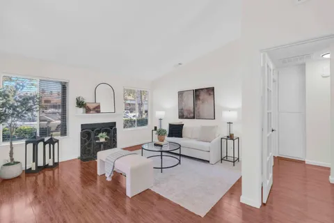a living room with furniture and a fireplace