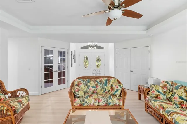a bedroom with furniture and a large window