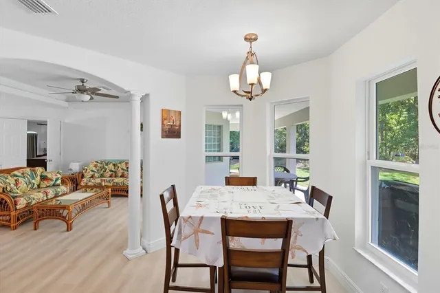 a living room with kitchen island furniture and a chandelier
