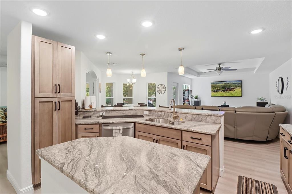 5032 North Crossgate Point Beverly Hills, FL 34465 - Photo 19 of 43 a large kitchen with stainless steel appliances kitchen island granite countertop a refrigerator and a stove top oven