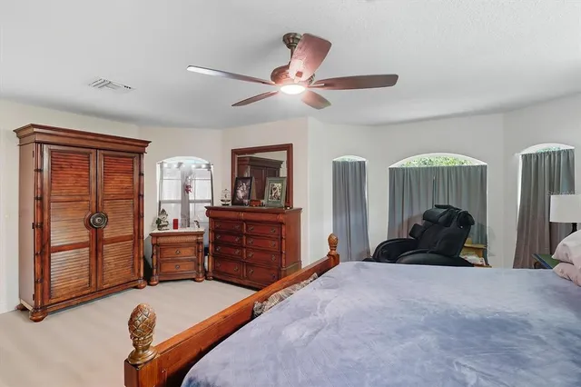 a bedroom with furniture and a large window