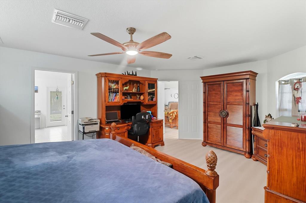 5032 North Crossgate Point Beverly Hills, FL 34465 - Photo 25 of 43 a bedroom with furniture and a large window