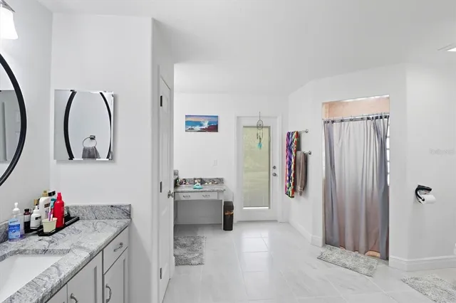 a bathroom with a double vanity sink mirror and a toilet