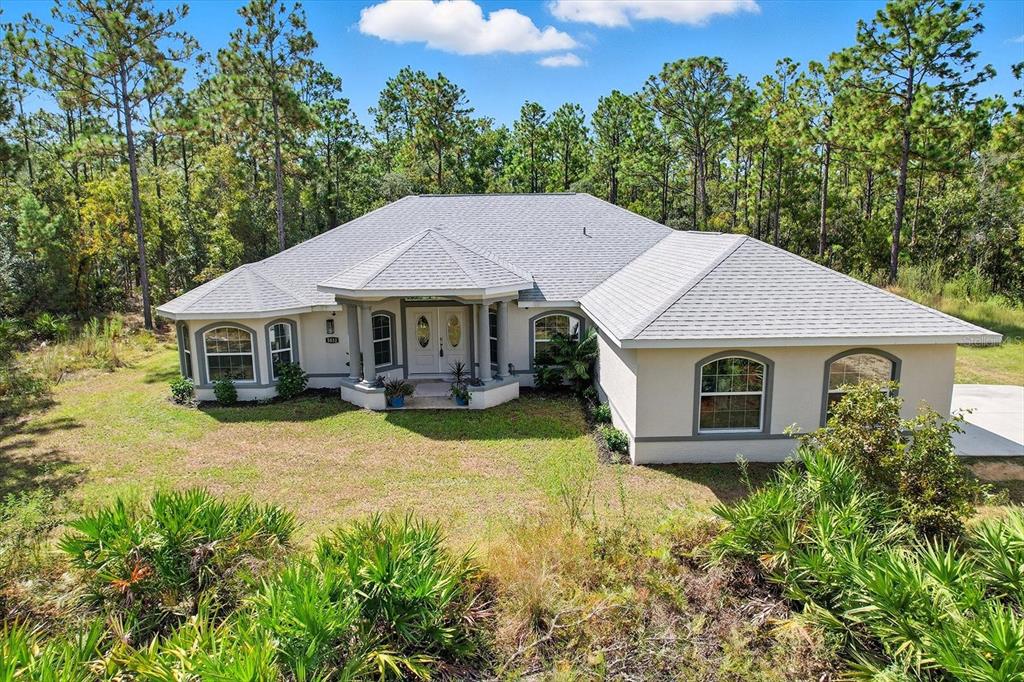 5032 North Crossgate Point Beverly Hills, FL 34465 - Photo 3 of 43 a front view of a house with yard and green space