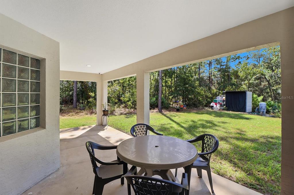 5032 North Crossgate Point Beverly Hills, FL 34465 - Photo 39 of 43 a view of an outdoor dining space with a table and chairs