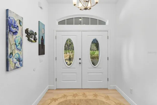 a living room with furniture a table and a large window