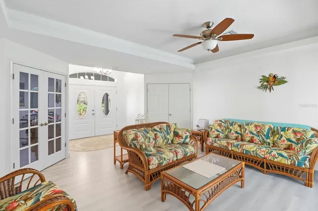 a bedroom with furniture and a large window