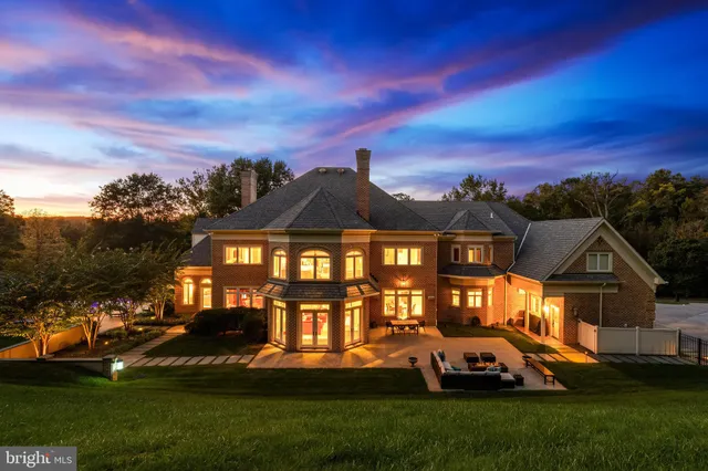 a living room with furniture fireplace and a large window