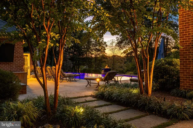 a view of a dining room with furniture a chandelier and wooden floor