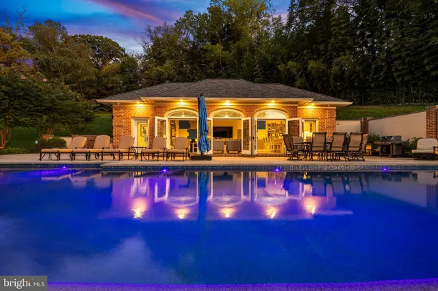 a living room with furniture fireplace and a large window