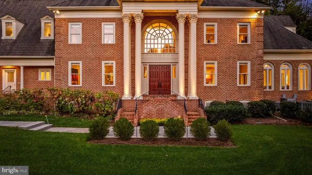 a front view of a house with a garden and yard
