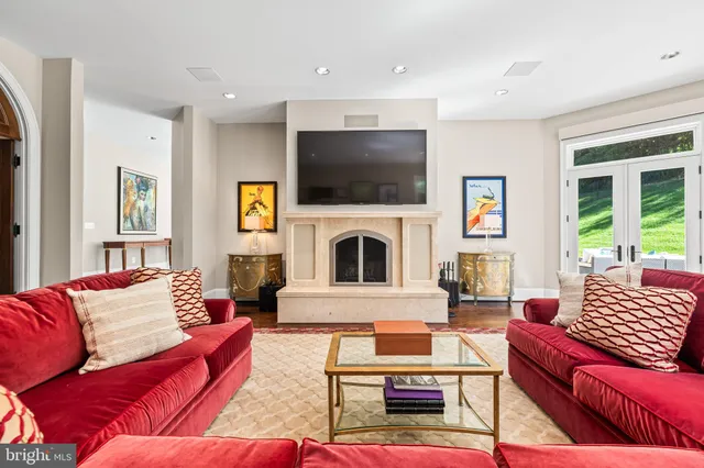 a living room with furniture a window and a flat screen tv