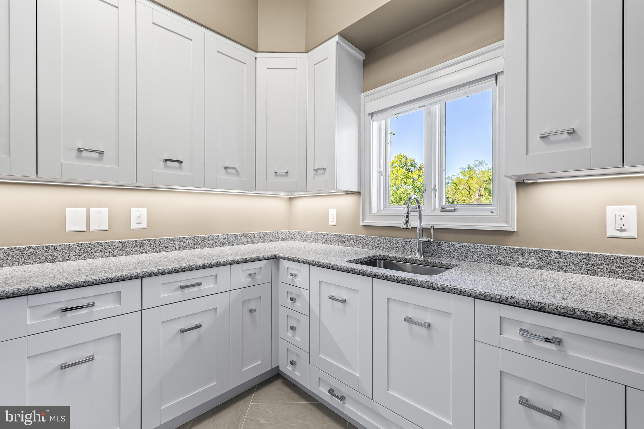 1421 Wine Spring Lane Baltimore, MD 21204 - Photo 72 of 150 a kitchen with granite countertop white cabinets and two sink