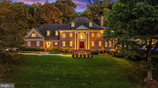a bathroom with a granite countertop sink a toilet and a mirror