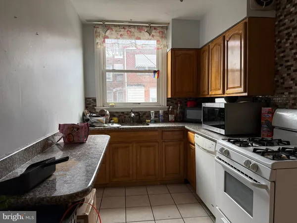 a kitchen with a stove a sink and a microwave
