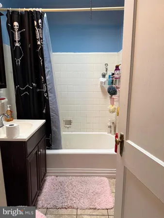 a bathroom with a bathtub sink and mirror